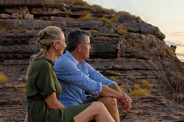 Two people sitting on rock
