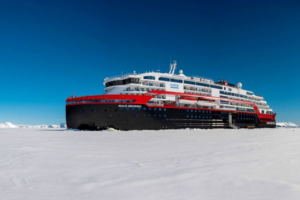 Hurtigruten ship surrounded by glaciers