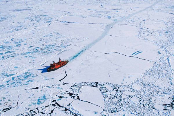 Expedition cruise ship cruising through glacier