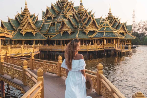 Lady in white dress with traditional temple/shrine in the background