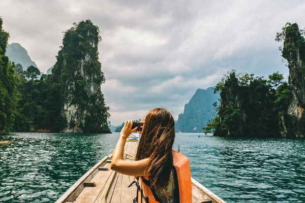 Lady in kayak cruising through the Phi Phi Islands