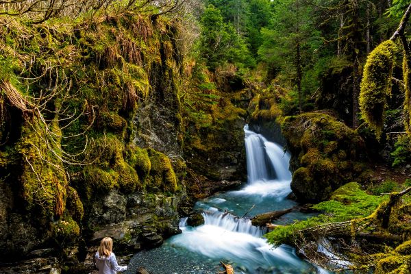 Lady in front of lake in forest
