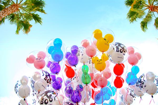 large bunch of mickey mouse balloons in the sky