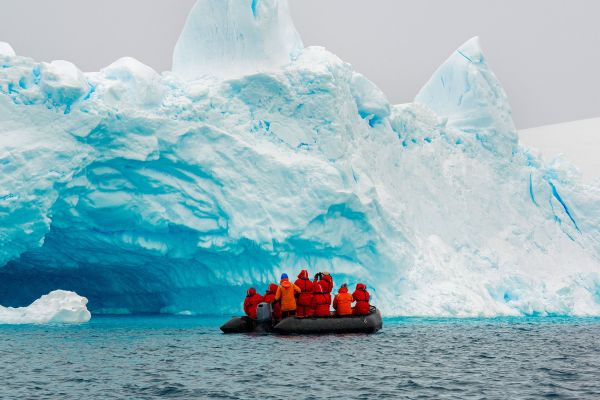 Expedition boat looking at iceberg