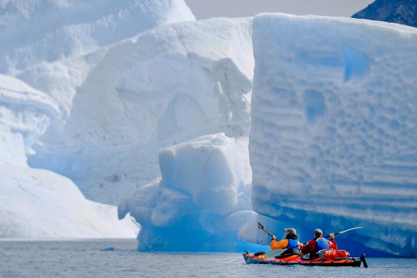 Expedition boat looking at iceberg