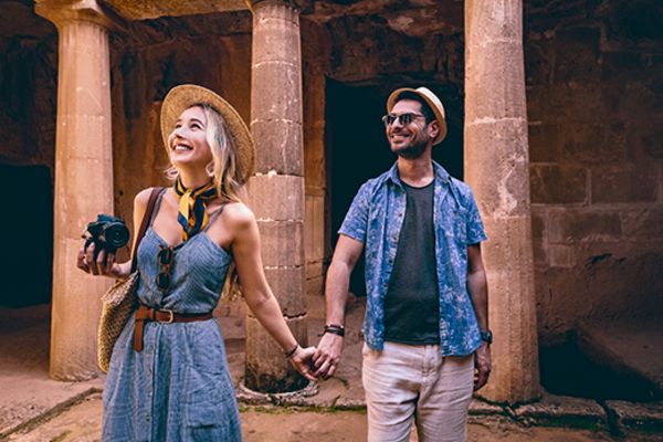 couple holding hands in ancient ruins smiling in athens