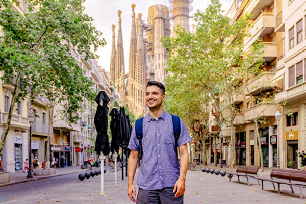 man smiling while walking down street in barcelona