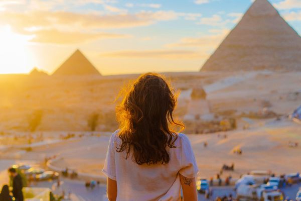 Standing in front of pyramids