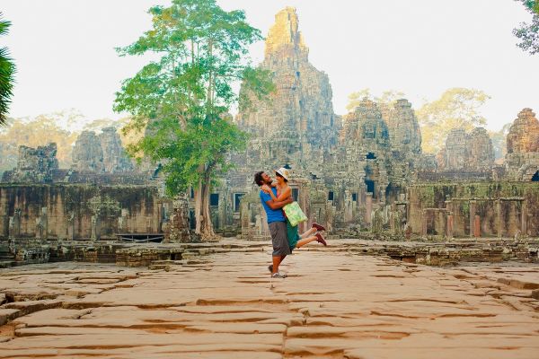 Couple visiting ancient temple, Angkor, Siem Reap, Cambodia