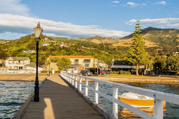 person walking along path near mountains in christchurch