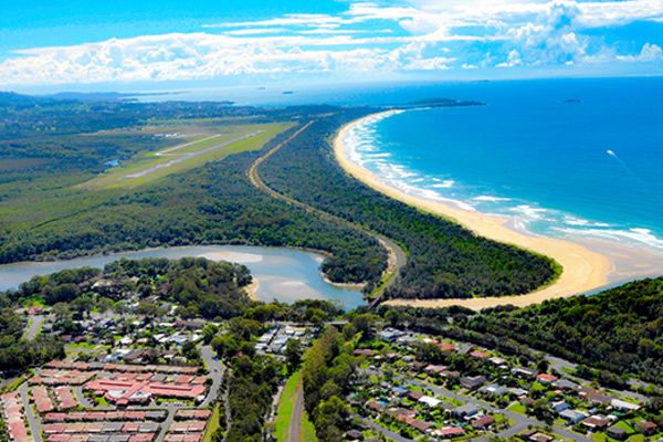 Wide shot of Coffs Harbour, showing the coastline, river, and airport