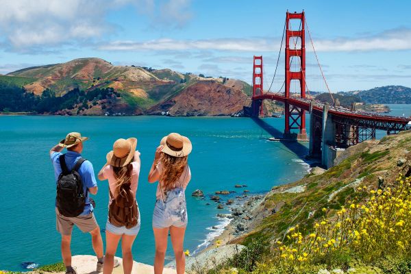 Three people looking at the Golden Gate Bridge