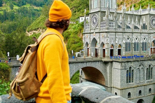 Man with backpack looking towards the Church of Las Lajas, Colombia