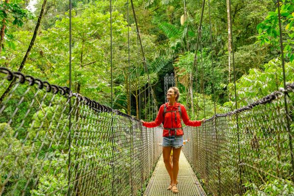 A woman taking in the views while on a hanging bridge in the jungle of Costa Rica