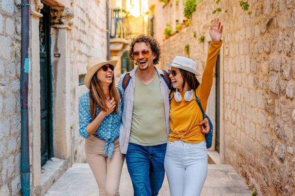 Three Young Friends Having Fun On The Street In Dubrovnik