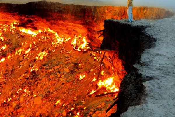Person standing on edge of volcano