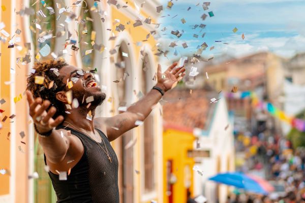 Man cheering, throwing confetti 