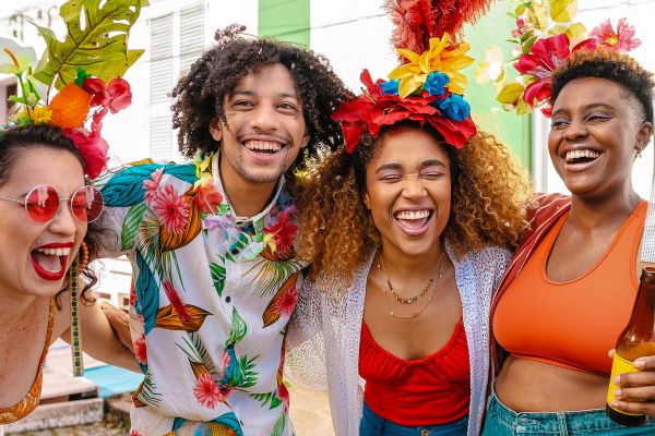 Four friends laughing wearing tropical clothing