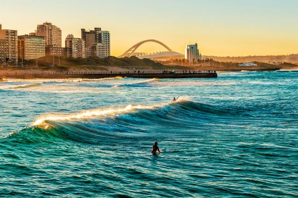 Surfer sitting on surf board in ocean