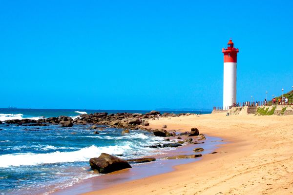 Beach with lighthouse in distance