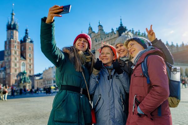Family sightseeing city on sunny but cold winter day.
