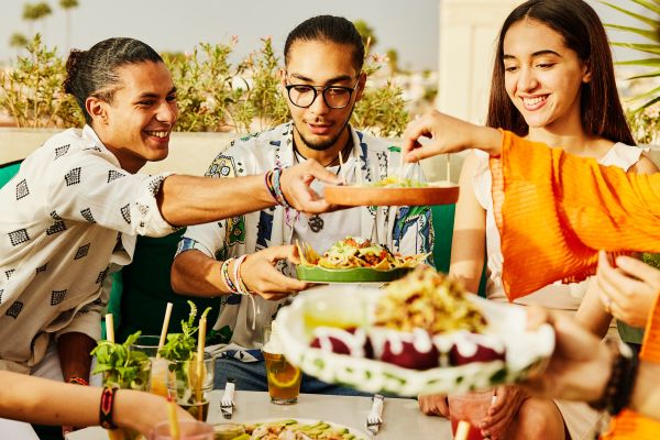 People sharing food on plates and bowls