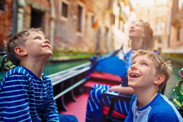 Kids gazing up sitting in a gondola