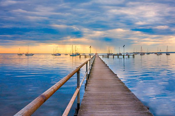 boardwalk over water in geelong at sunset