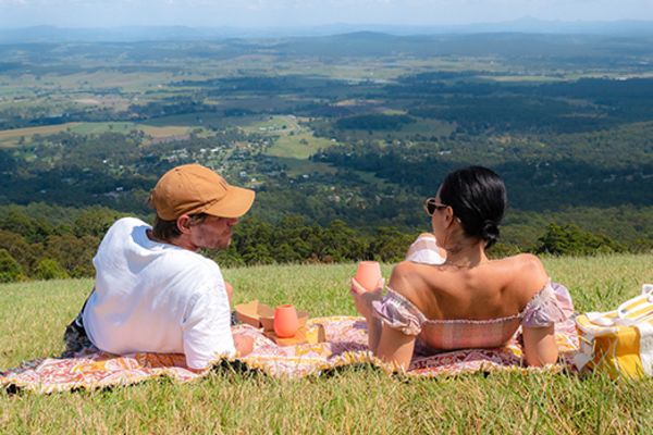 Couple having a picnic on a grassy hill