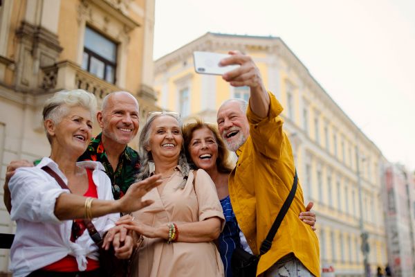 Group of elderly friends taking a selfie in a European street
