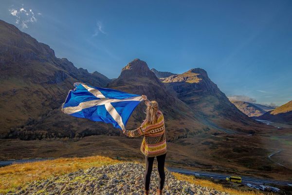 Holding Scottish flag in the highlands