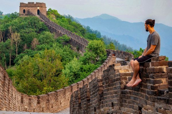 Man sitting on the Great Wall of China