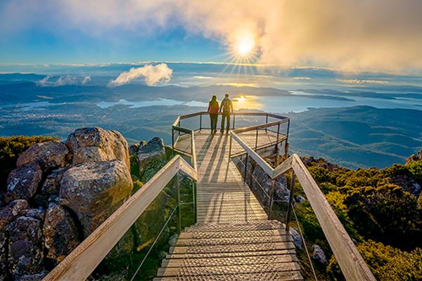 Couple on a viewing platform in Hobart looking at the sunset