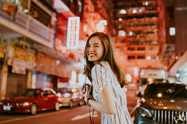 Smiling woman in the City of Hong Kong at night