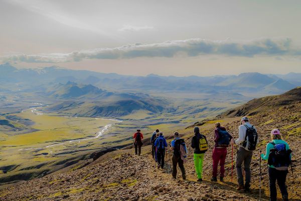Group of people walking through rolling hills