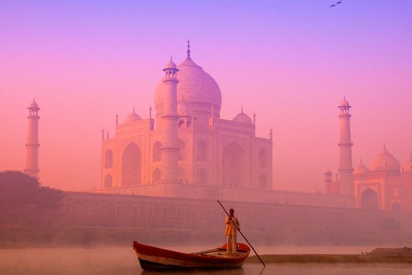 India, Uttar Pradesh, Agra, Yamuna river with boatman at dawn