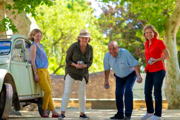 Friends playing bowls in a carpark