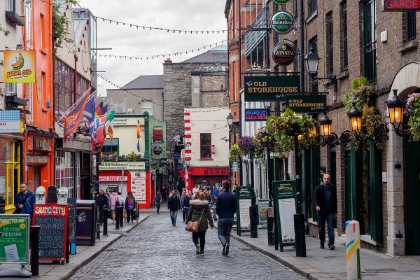 Quiet city street in Ireland lined with pubs and shops
