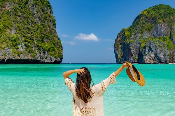 Woman in a white shirt looking out at the ocean