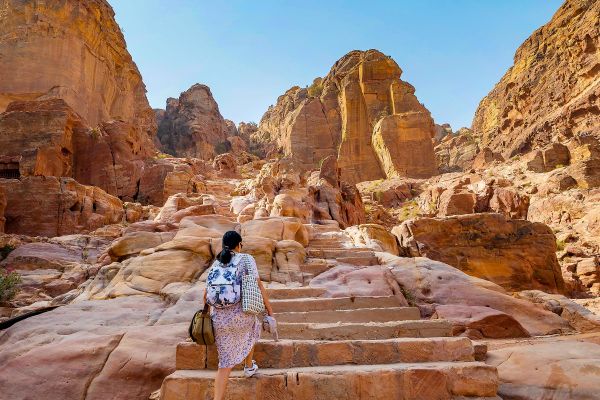 Woman climbing rocky stairs