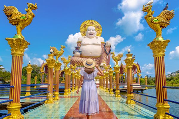 lady walking towards temple in Koh Samui