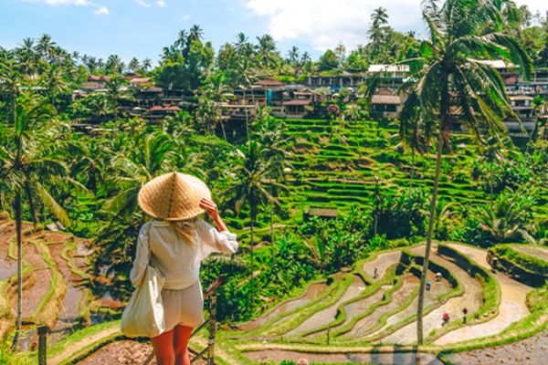 Woman looking out at terraced farms in Bali