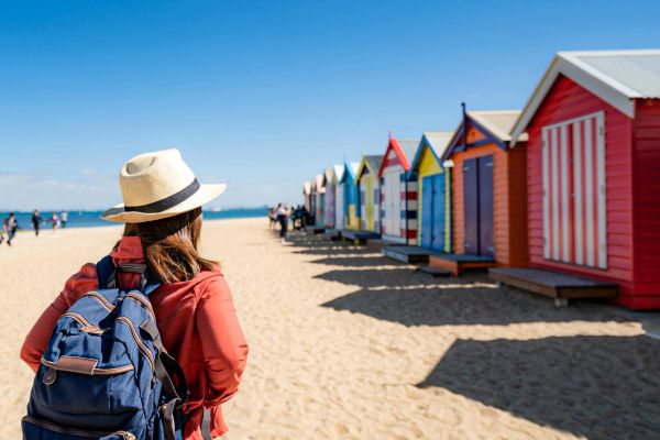 Lady on a beach admiring the Brighton bath boxes
