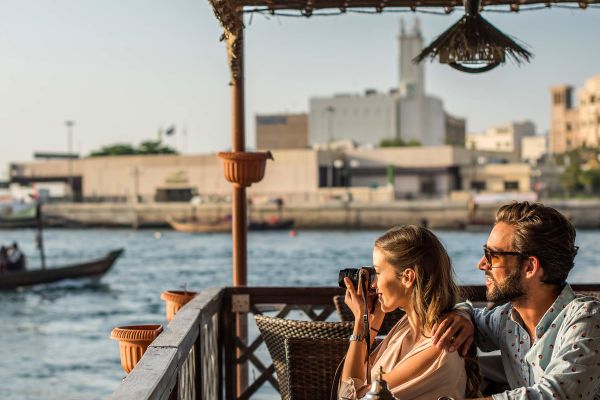 Two people sitting at restaurant along the water