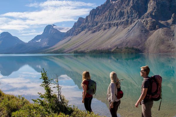 People hiking around a lake