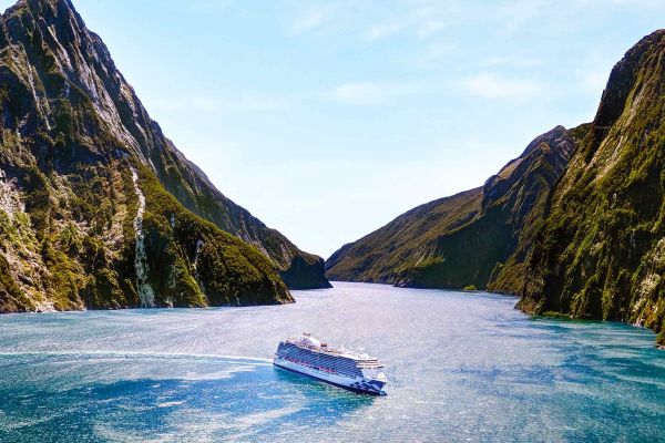 Drone shot of a Princess Cruises ship surrounded by mountains
