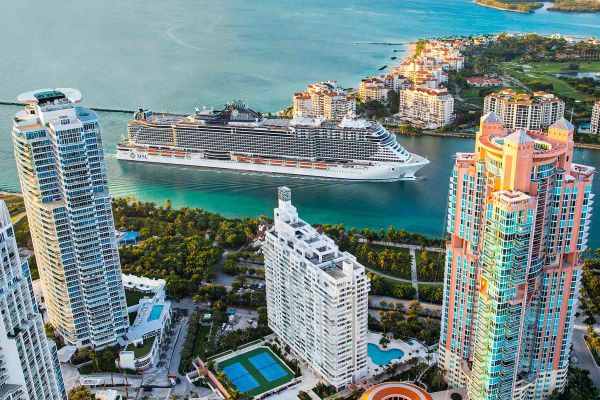Cruise ship with city in background