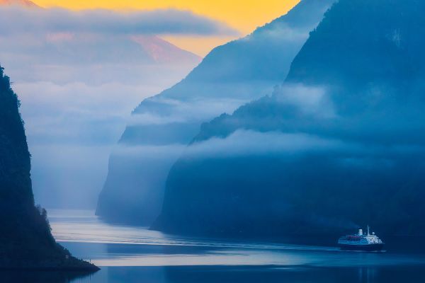 Misty sunset shot of water and mountains