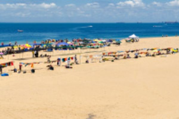 A view of a large beach with holidaymakers on a Portuguese island that can be visited via a Portuguese island cruise from South Africa.