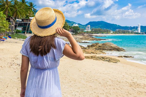 lady with straw hat on a beach 